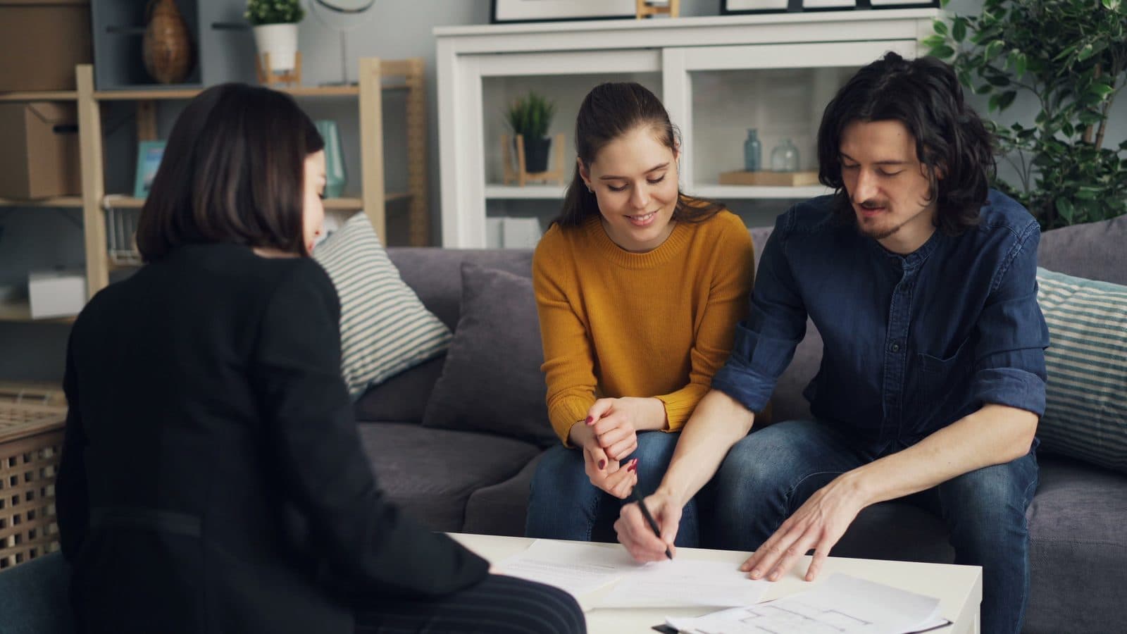 A seller signing listing paperwork with their agent