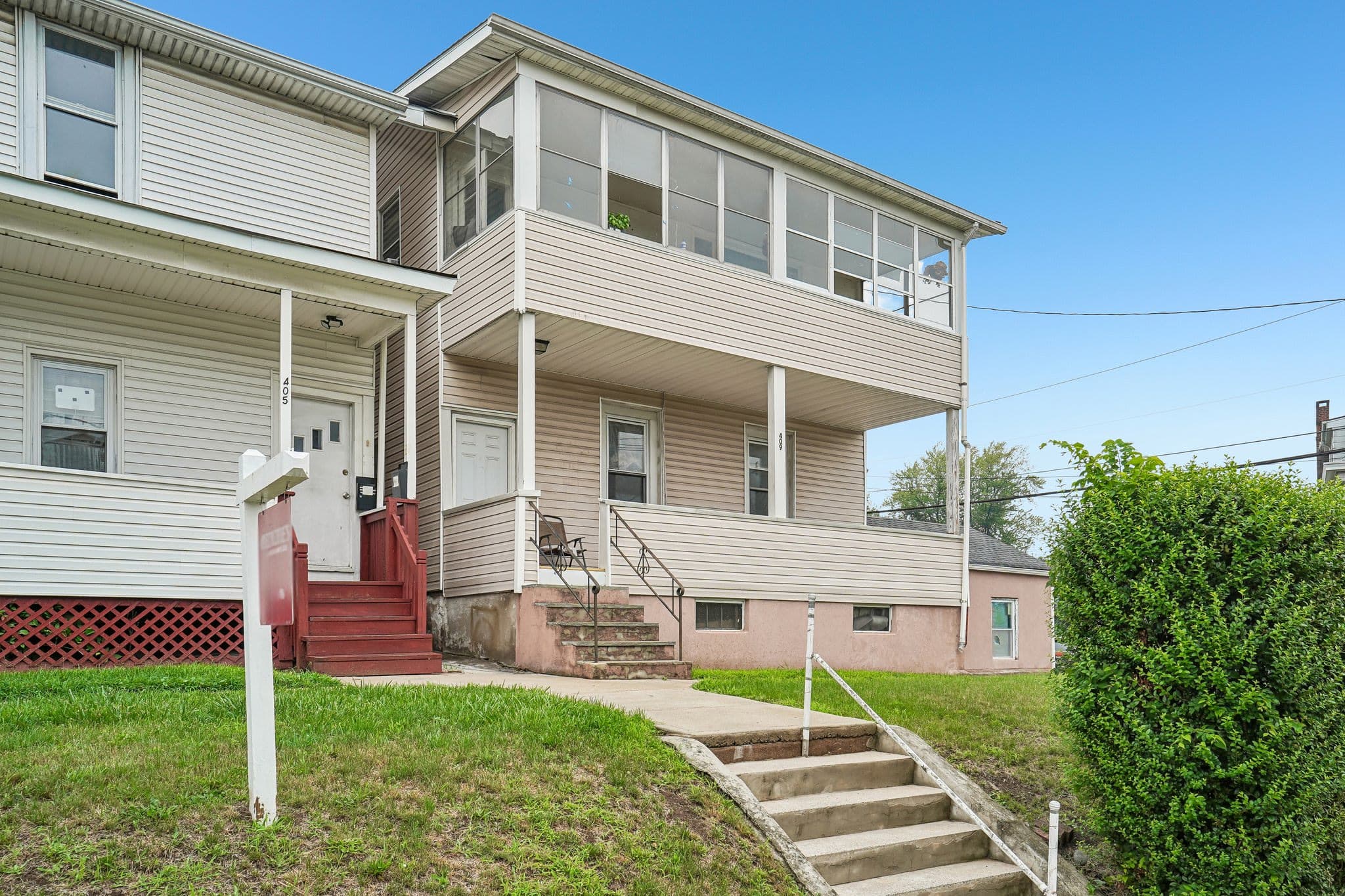 Two-family home with a front porch and an enclosed second-floor sunporch in Prospect Park, New Jersey